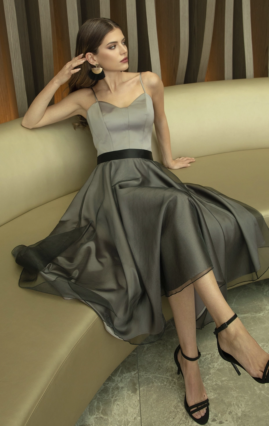 Elegant grey-beige strappy top paired with a flared grey satin and black tulle skirt.