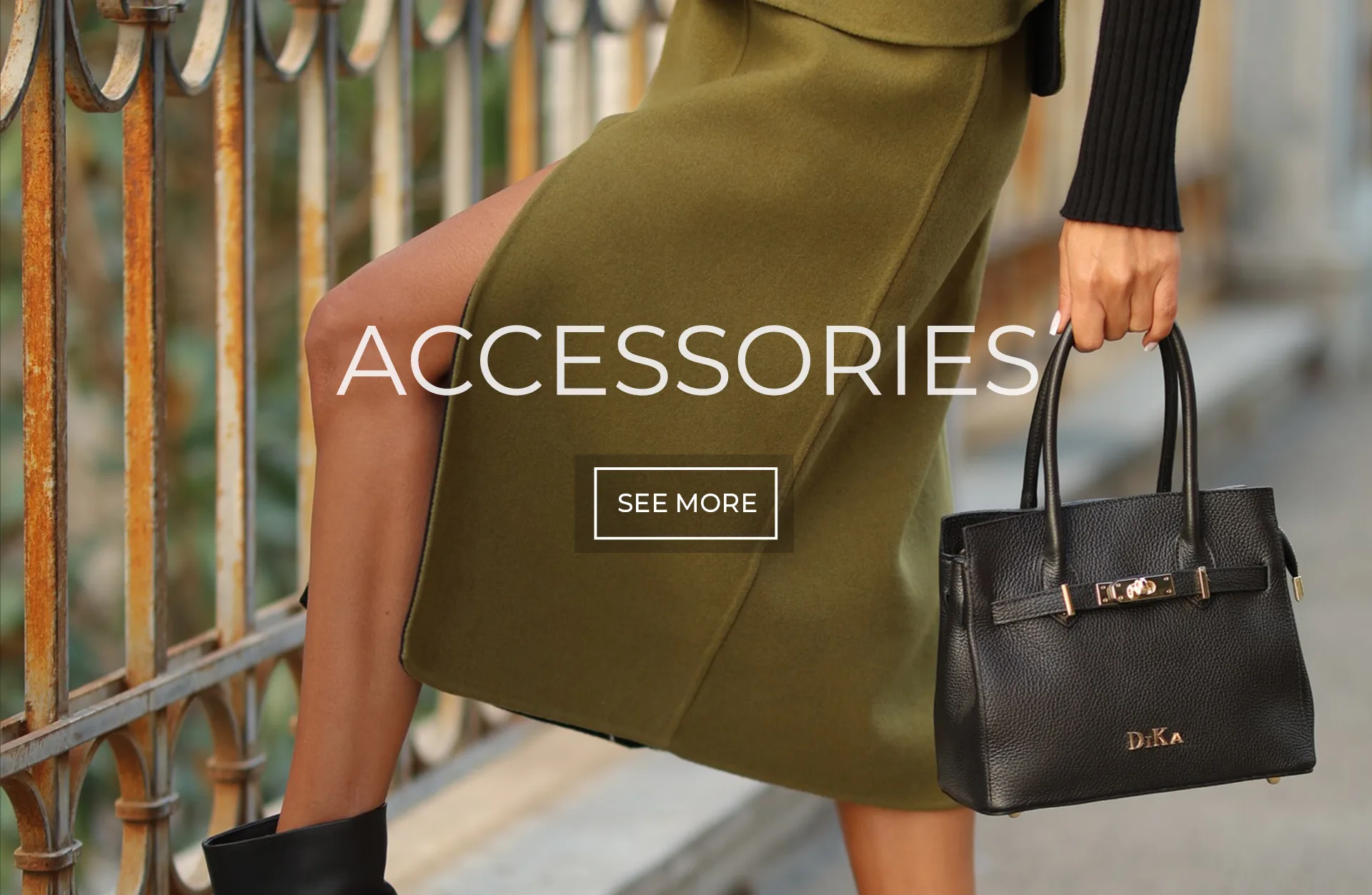 Women’s Accessories | DiKa Model carrying a black DiKa handbag with an olive green skirt