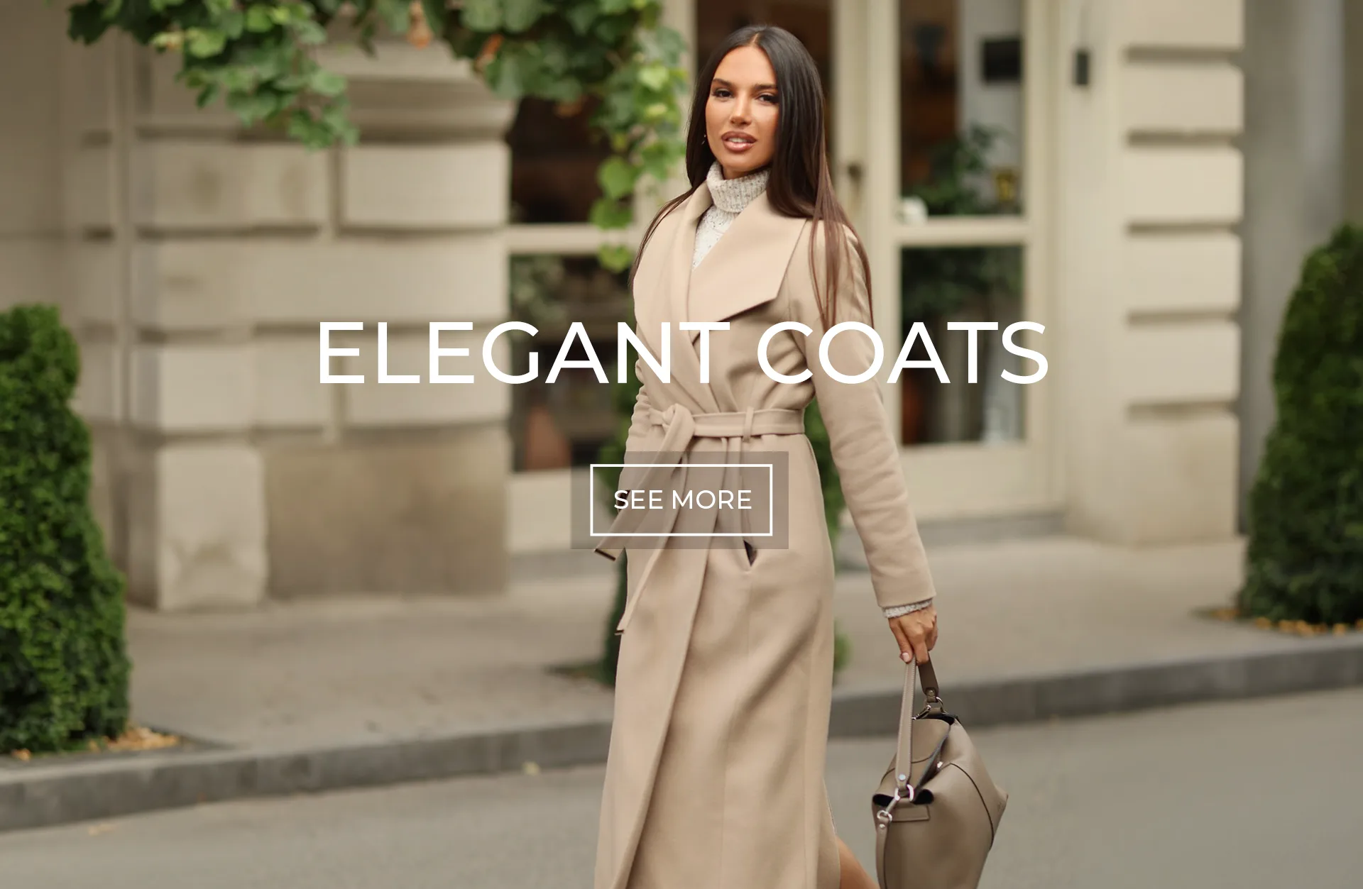 Elegant Women’s Coats | DiKa Model wearing a long beige belted coat by DiKa