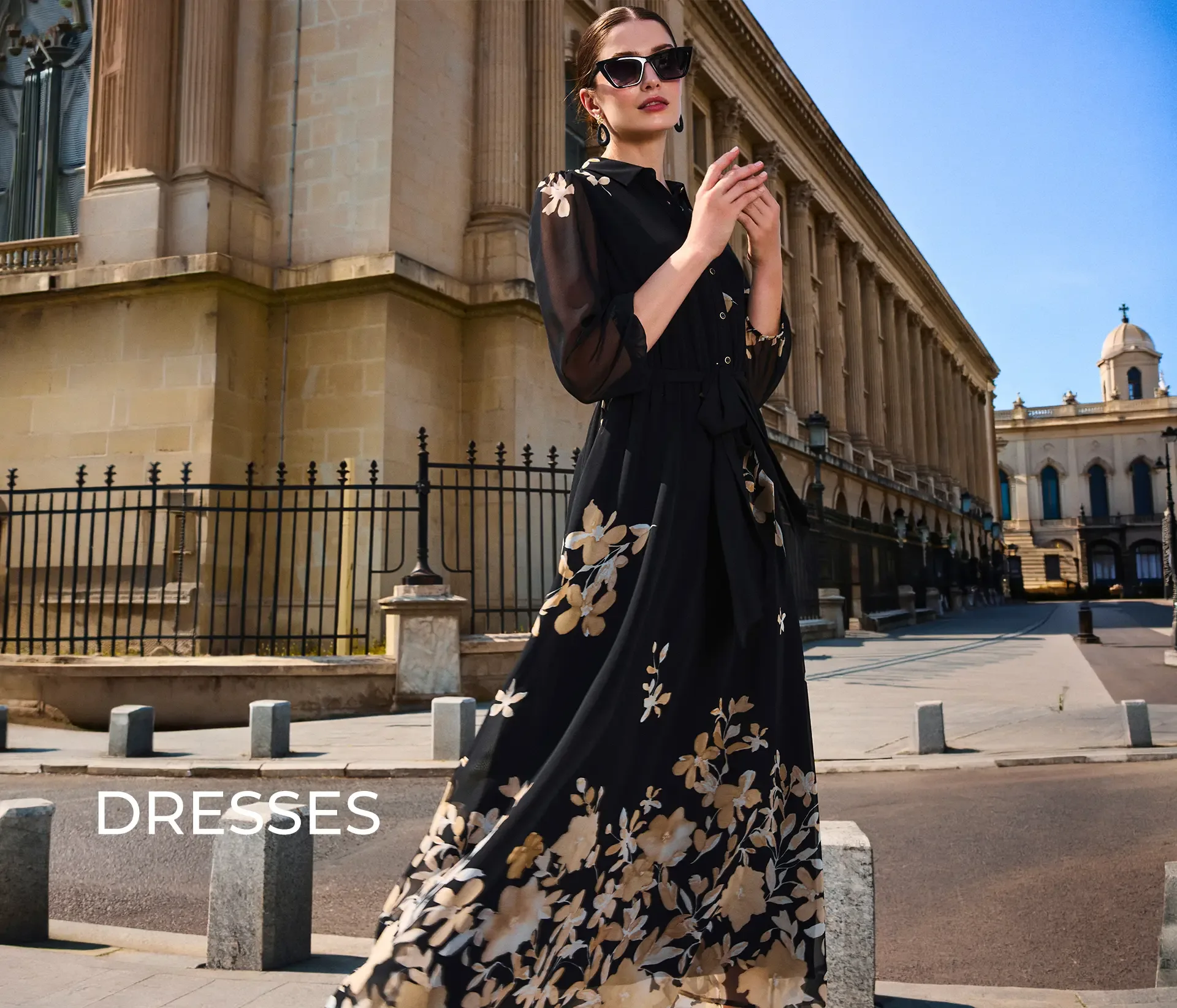 Women’s Dresses | DiKa Model wearing a long black floral dress by DiKa