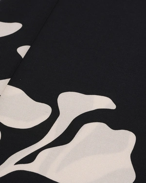 Black relaxed trousers with stylized beige floral motif | Trousers and Leggings - 2