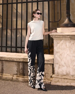 Black relaxed trousers with stylized beige floral motif | Trousers and Leggings - 3
